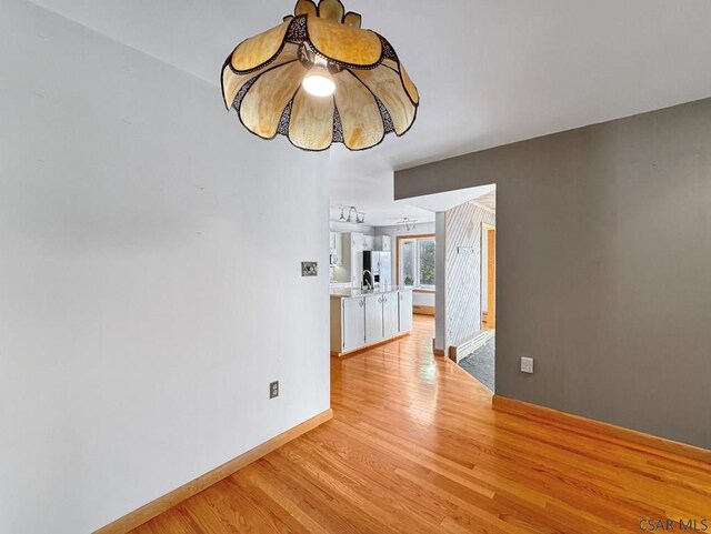 unfurnished dining area featuring light hardwood / wood-style flooring