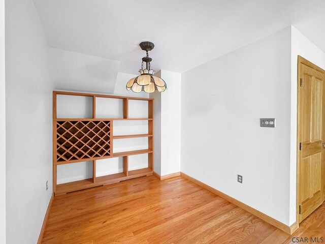 interior space featuring light hardwood / wood-style floors and a notable chandelier