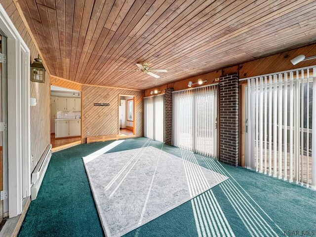 interior space featuring a baseboard heating unit, wooden ceiling, and ceiling fan