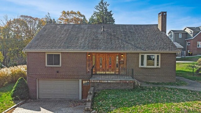 view of front of house with a garage and a front yard