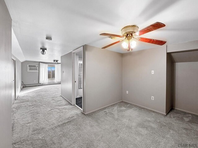 additional living space with ceiling fan, lofted ceiling, light carpet, and a wall unit AC