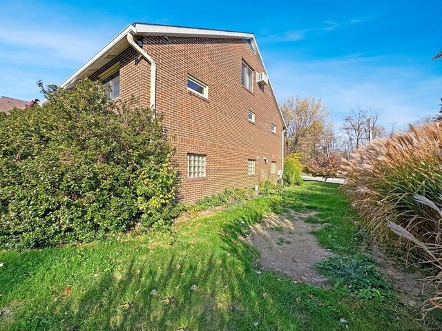 view of side of home with a yard