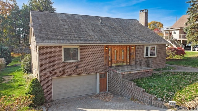 view of front of property with a garage and a front lawn