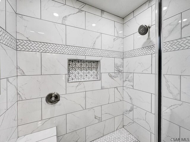 bathroom with tiled shower