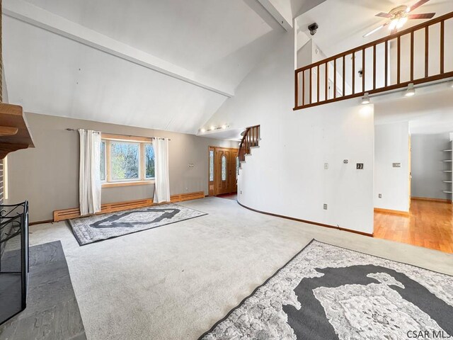 living room with high vaulted ceiling, beamed ceiling, light colored carpet, ceiling fan, and baseboard heating