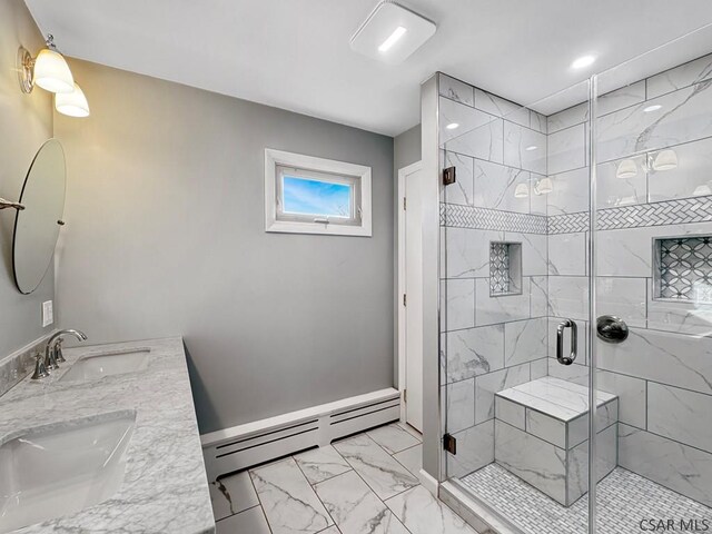 bathroom featuring vanity, a baseboard heating unit, and a shower with shower door