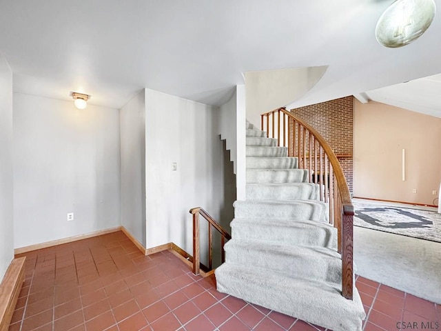 staircase featuring tile patterned flooring