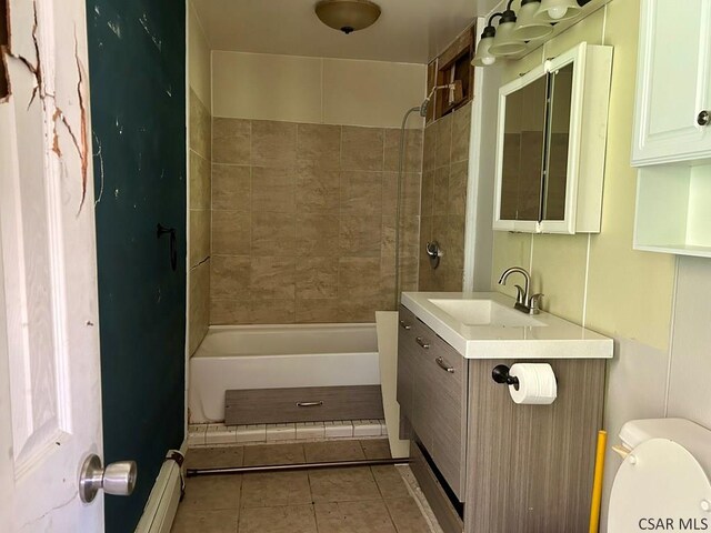 full bathroom featuring vanity, toilet, tiled shower / bath combo, and tile patterned flooring