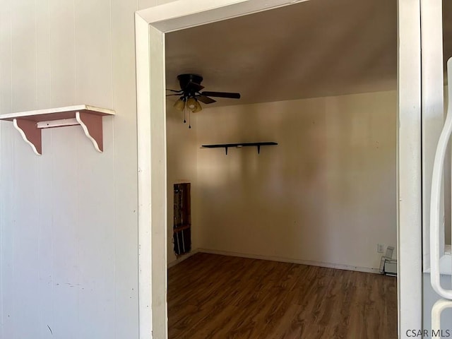 walk in closet with a baseboard heating unit, dark hardwood / wood-style floors, and ceiling fan