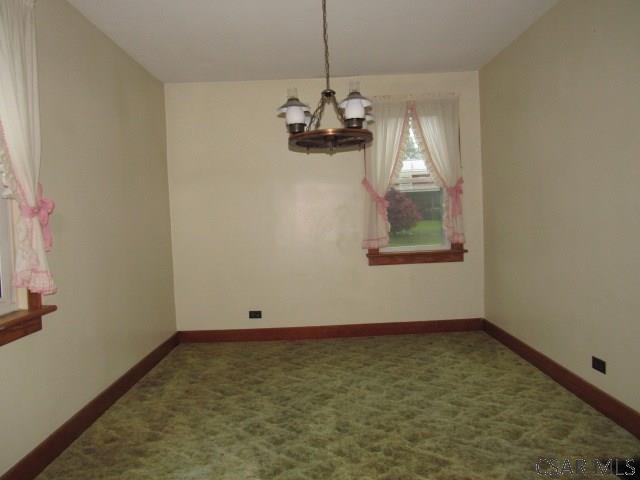619 W Race St, Somerset, PA 15501 - unfurnished dining area featuring a chandelier, carpet, and baseboards