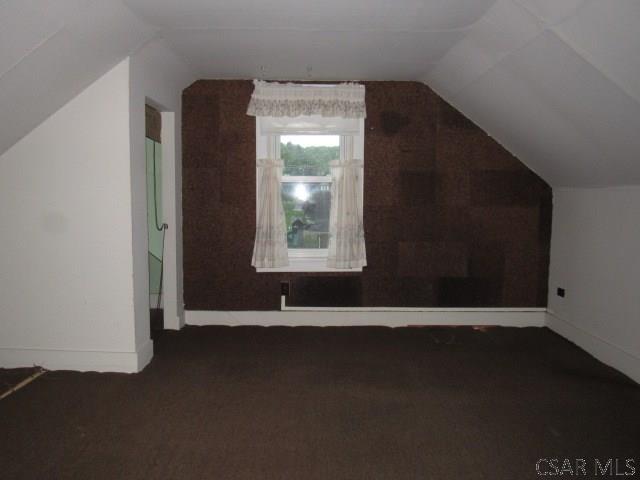 619 W Race St, Somerset, PA 15501 - additional living space with vaulted ceiling, carpet, and baseboards