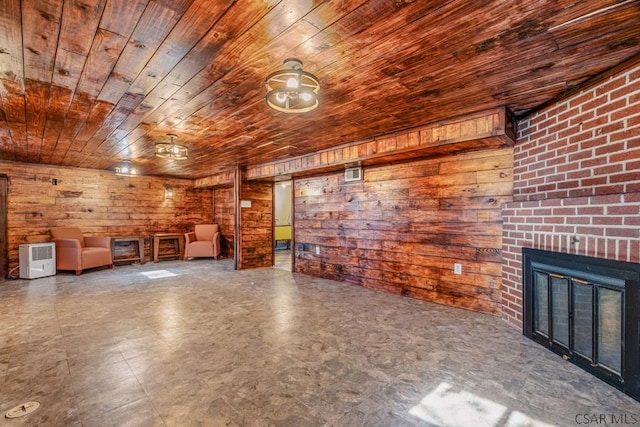 unfurnished living room featuring a brick fireplace, wooden ceiling, and wood walls