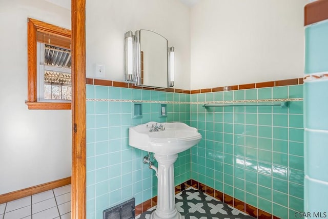 bathroom featuring tile patterned flooring, visible vents, tile walls, and wainscoting