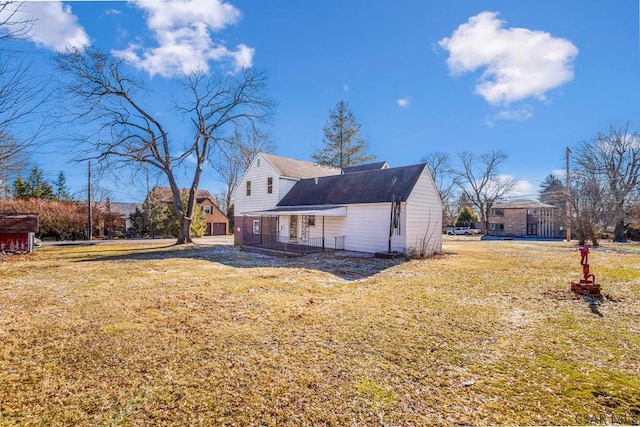 view of side of property with a yard