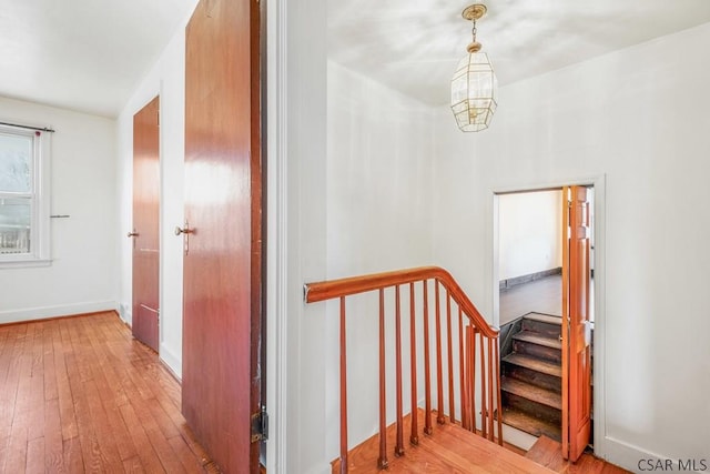 stairway with hardwood / wood-style floors and baseboards