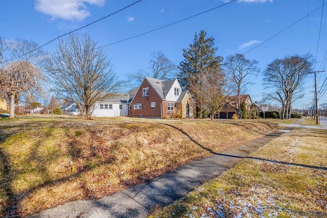 view of side of home with a yard