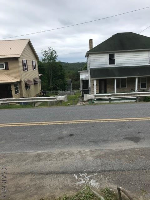 532 1st St, Windber, PA 15963 - view of property exterior featuring a chimney and a porch