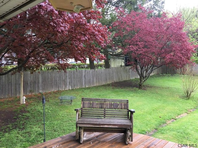 wooden deck featuring a yard