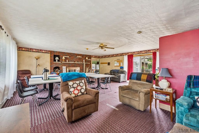 carpeted living room featuring ceiling fan, a brick fireplace, and a textured ceiling