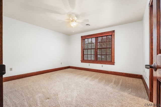 carpeted empty room featuring ceiling fan