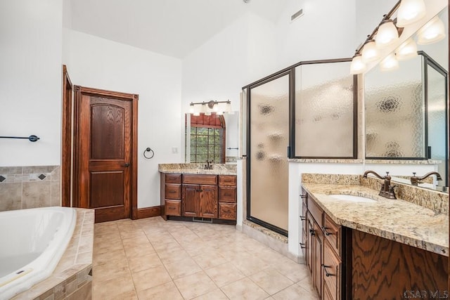 bathroom with independent shower and bath, vanity, and tile patterned floors