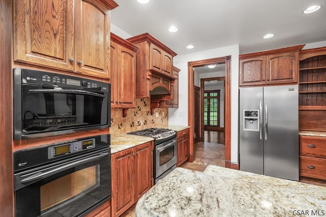 kitchen with light tile patterned floors, stainless steel appliances, tasteful backsplash, light stone countertops, and custom exhaust hood