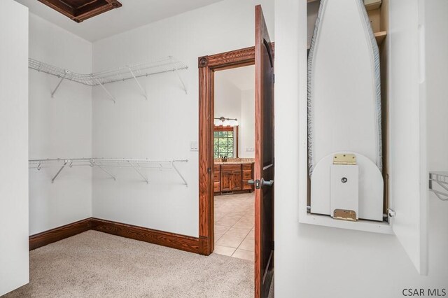 spacious closet with light tile patterned floors