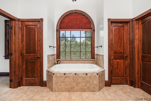 bathroom featuring tiled tub and tile patterned floors