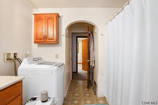 laundry area with cabinets and washing machine and clothes dryer