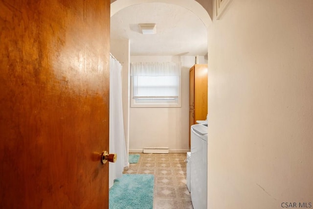 laundry room featuring separate washer and dryer and a baseboard radiator