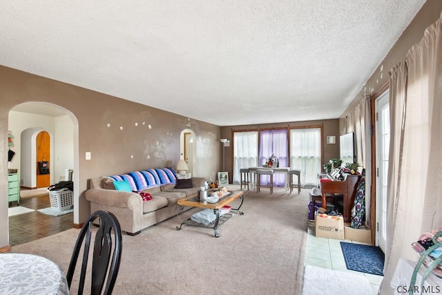 living room featuring carpet floors and a textured ceiling