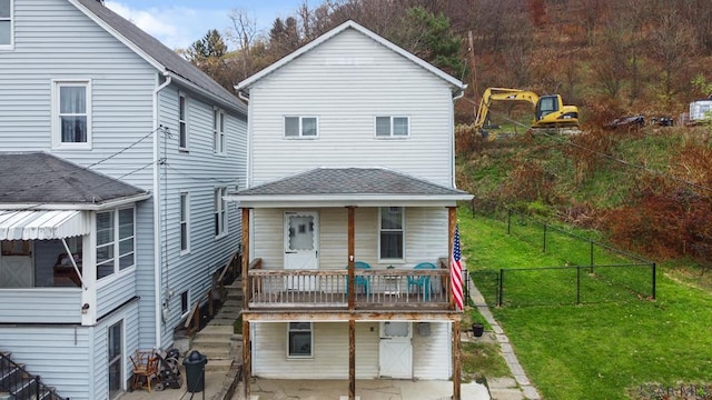 back of house featuring a patio area and a lawn