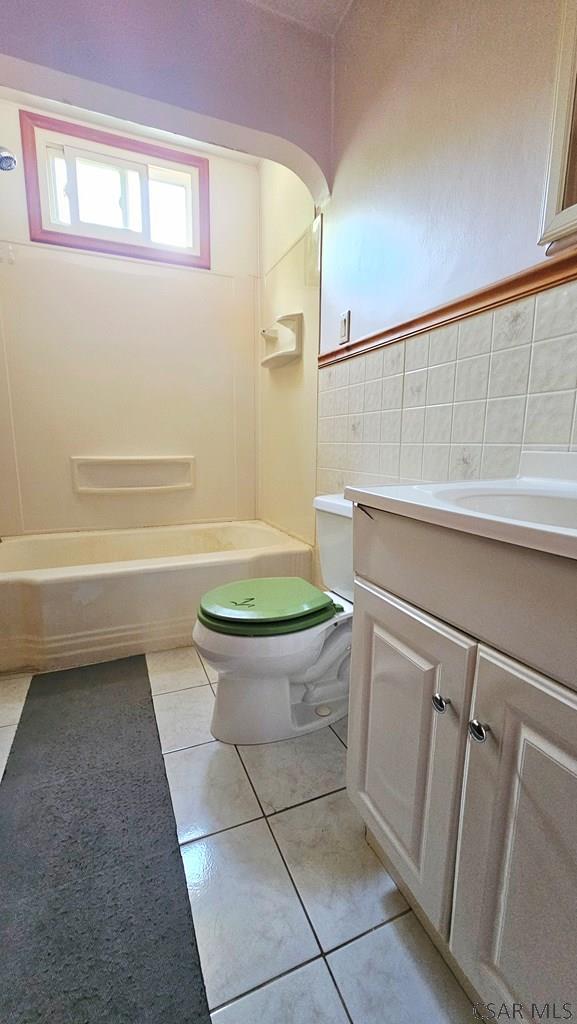 241 Grazier St, Johnstown, PA 15906 - bathroom featuring vanity, tub / shower combination, tile walls, and tile patterned floors