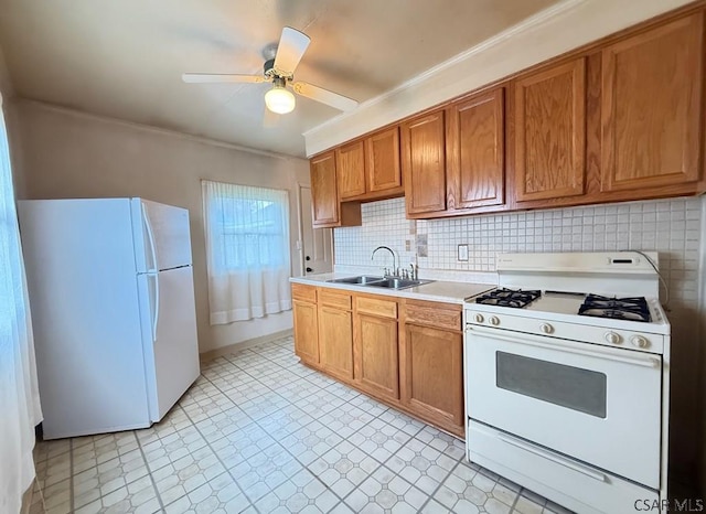 kitchen featuring a sink, white appliances, brown cabinets, ornamental molding, and light countertops