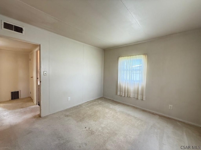 spare room featuring carpet and visible vents