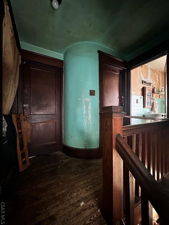 hallway with dark wood-type flooring