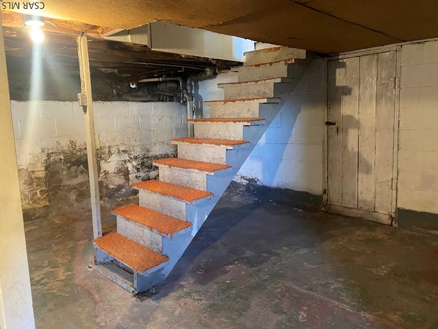 unfinished basement with stairway