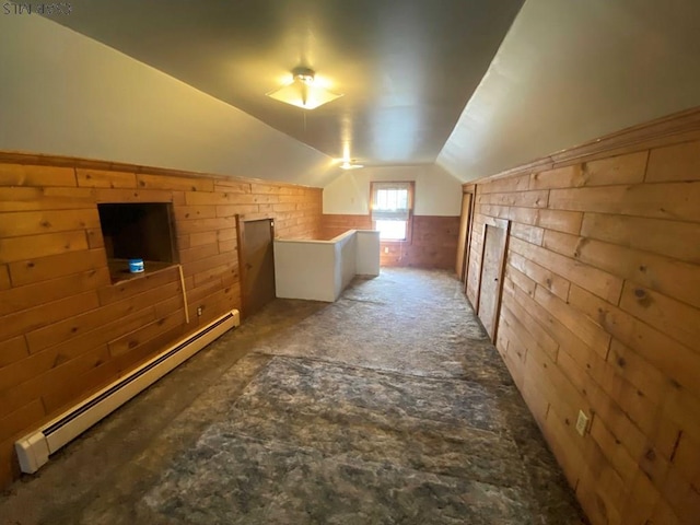 bonus room featuring wood walls, lofted ceiling, and a baseboard radiator