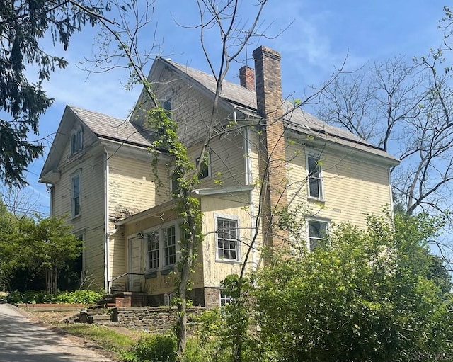 424 W Main St, Stoystown, PA 15563 - view of property exterior with a chimney and roof with shingles