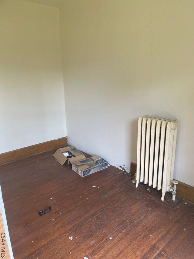 424 W Main St, Stoystown, PA 15563 - unfurnished room with radiator and hardwood / wood-style flooring