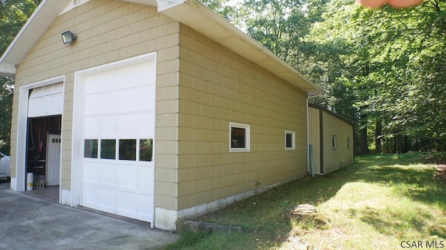 view of home's exterior with an outbuilding