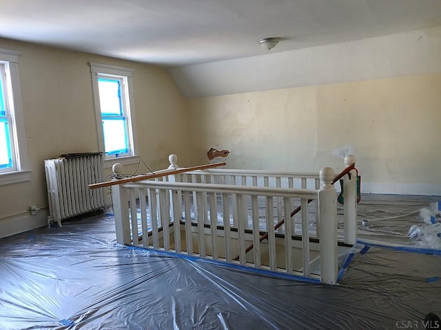 additional living space with lofted ceiling and radiator