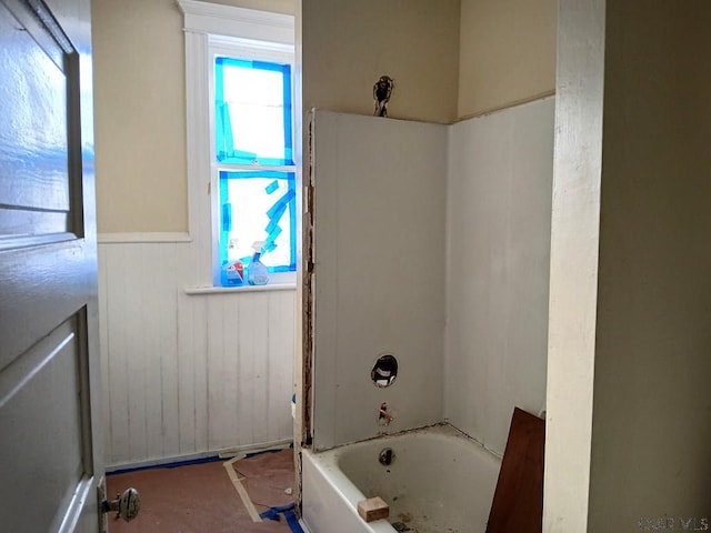 bathroom featuring wood walls