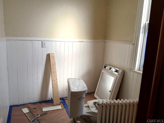 laundry area with radiator and washer / dryer