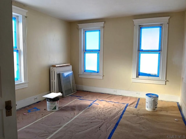 unfurnished living room featuring radiator heating unit