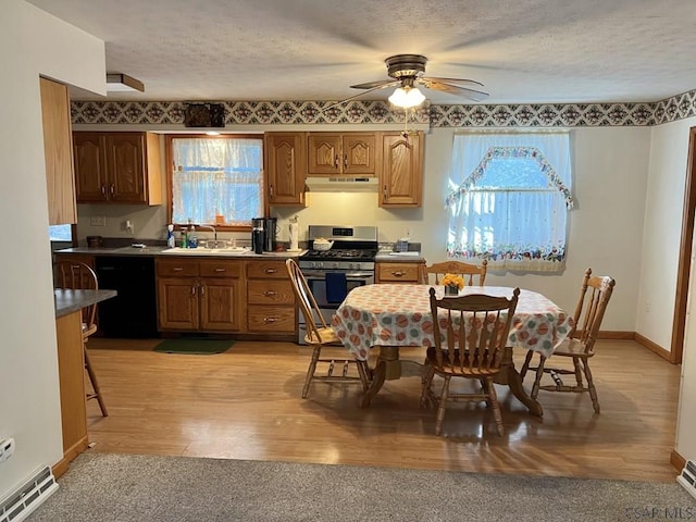 kitchen with sink, gas range, a textured ceiling, black dishwasher, and light hardwood / wood-style floors