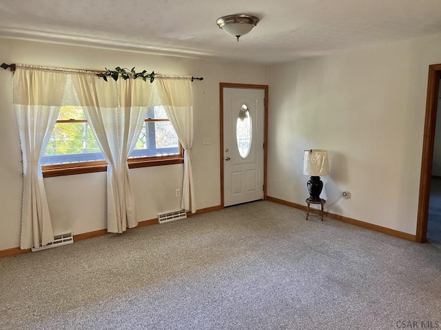 foyer with carpet flooring