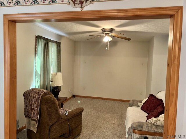 living room featuring ceiling fan and carpet