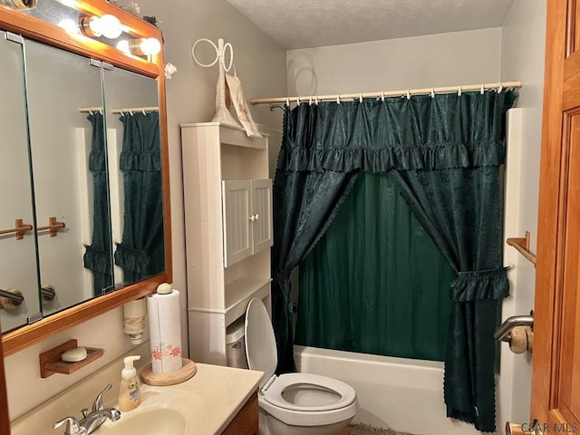 full bathroom with vanity, shower / bath combo, toilet, and a textured ceiling