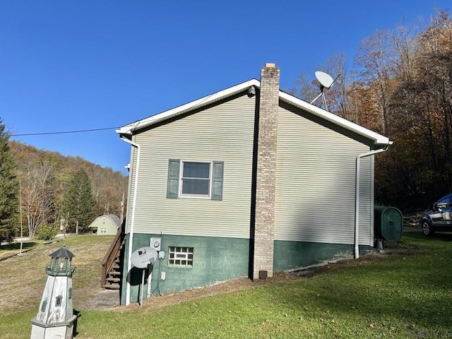 view of side of home featuring a lawn